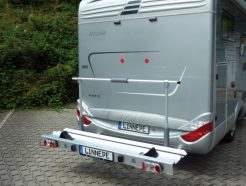 A stunning silver motorhome with the linnepe Porto bike carrier attached at the back